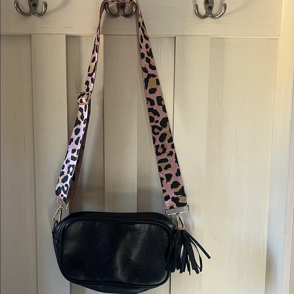 Black pebbled crossbody bag with guitar strap